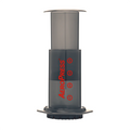 AeroPress coffee maker in black with red logo and measurement markings for brewing coffee
