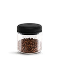 Fellow Atmos Vacuum Canister Clear Glass with black lid storing coffee beans
